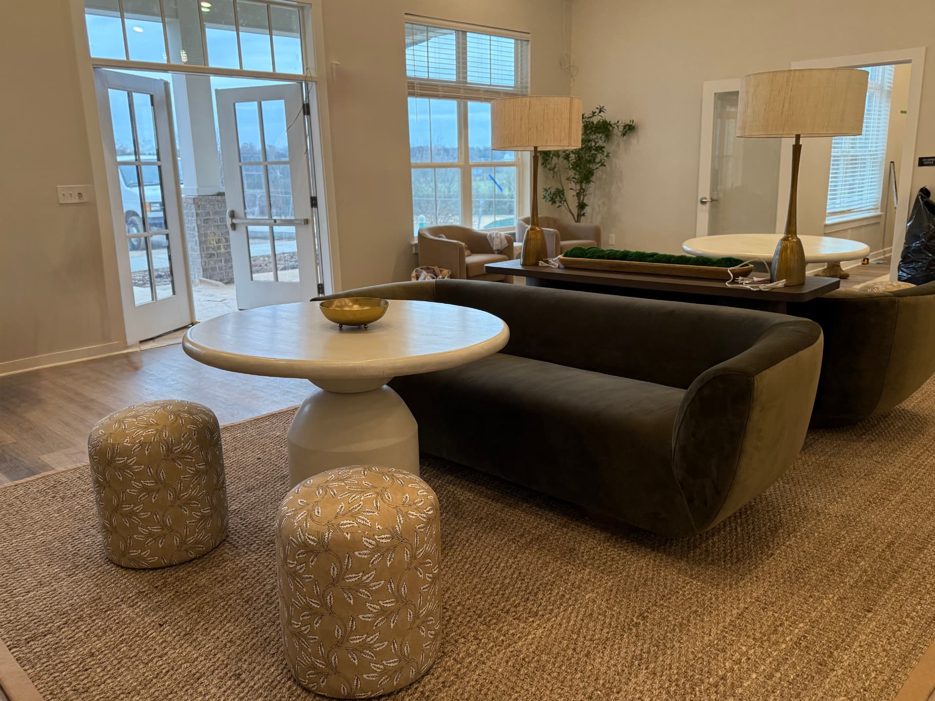 Clubhouse lounge install with curved sofa and sisal rug
